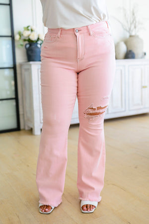 Feminine Flair Mid Rise Distressed Flares in Pastel Pink