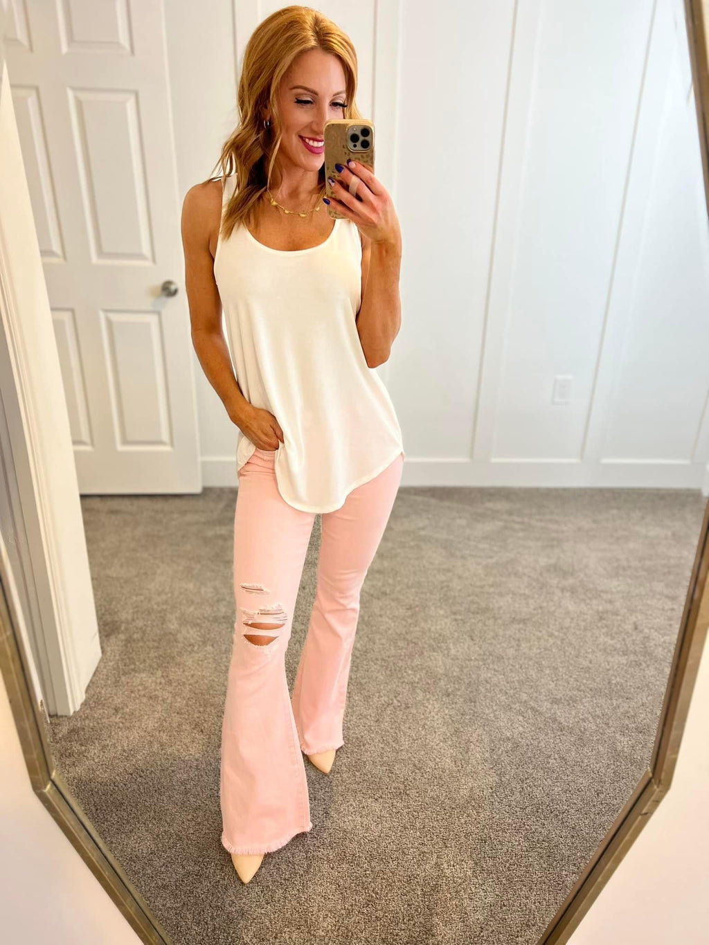 Feminine Flair Mid Rise Distressed Flares in Pastel Pink